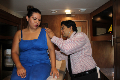 Woman receiving care inside the Regional Center for Border Health mobile clinic