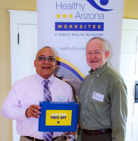 Mr. Javier Morales (left), Director of Public Health Initiatives with RCBH, received the award on behalf of Ms. Aguirre.